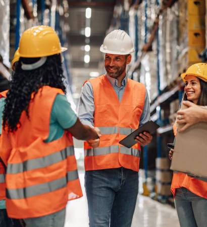 Warehouse,Workers,In,Reflective,Vests,And,Hard,Hats,Celebrate,Closing